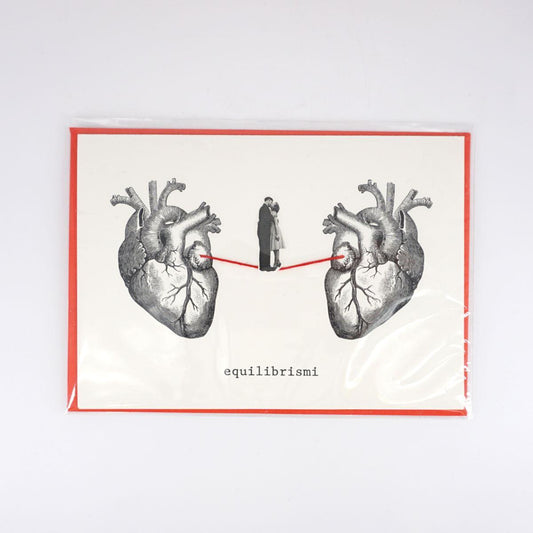 Balancing card between two hearts KISS